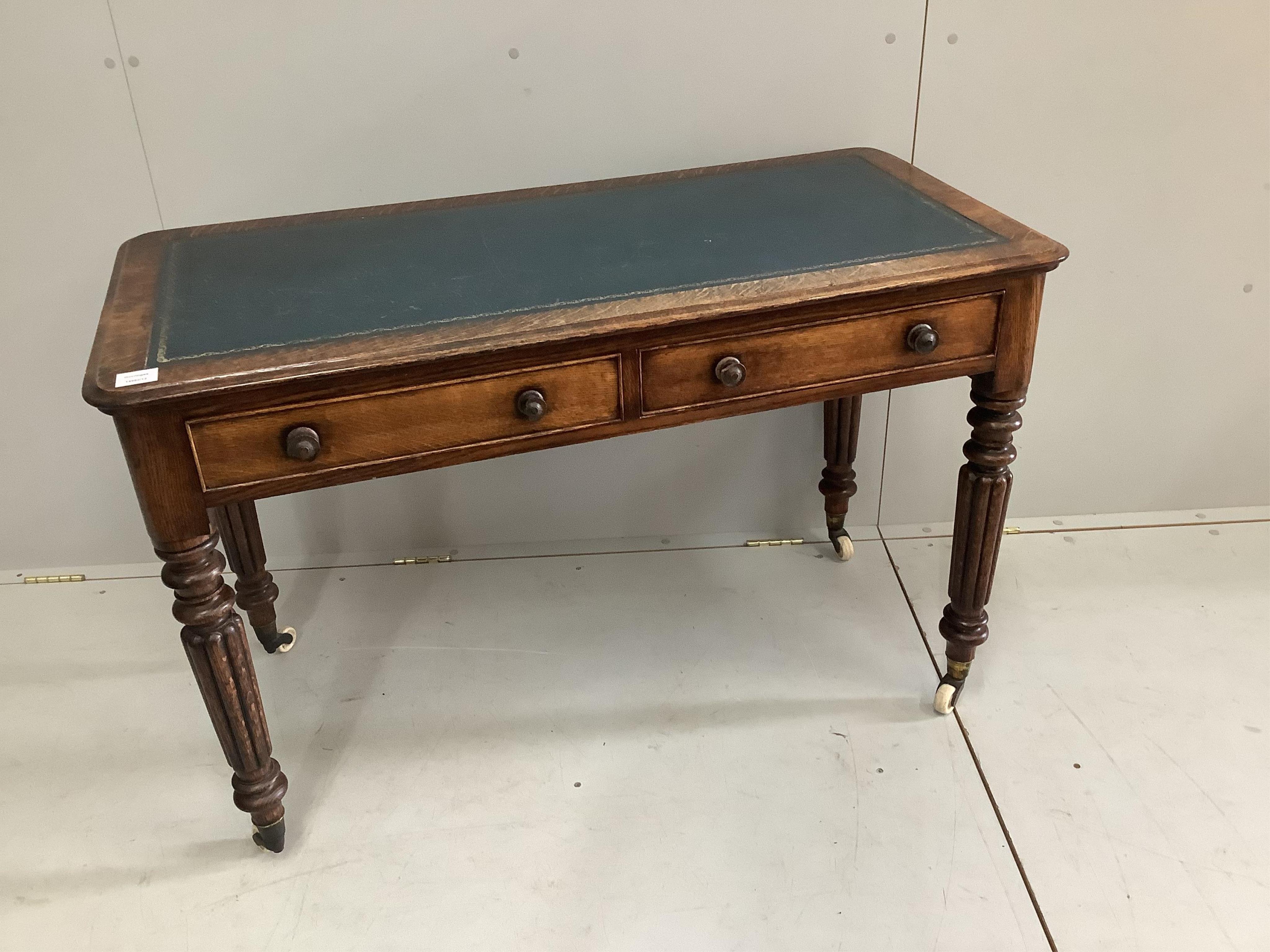 A Victorian oak two drawer writing table, width 114cm, depth 55cm, height 73cm. Condition - fair